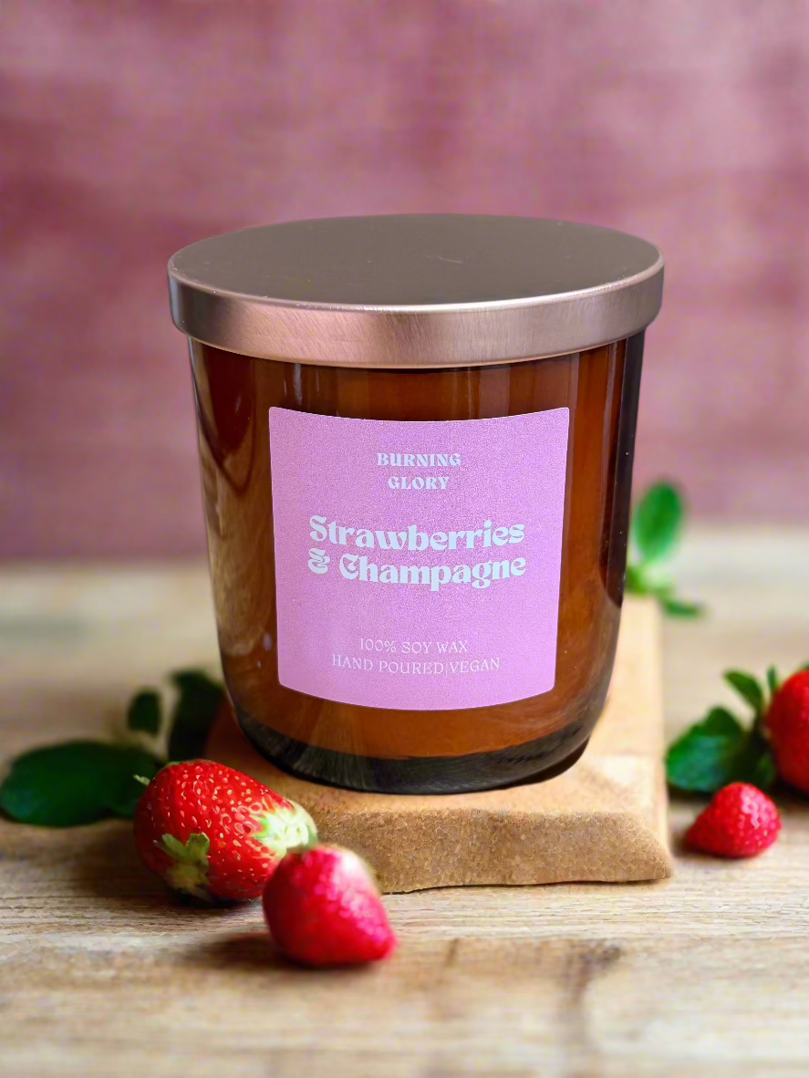 Candle with a pink label on a wooden surface